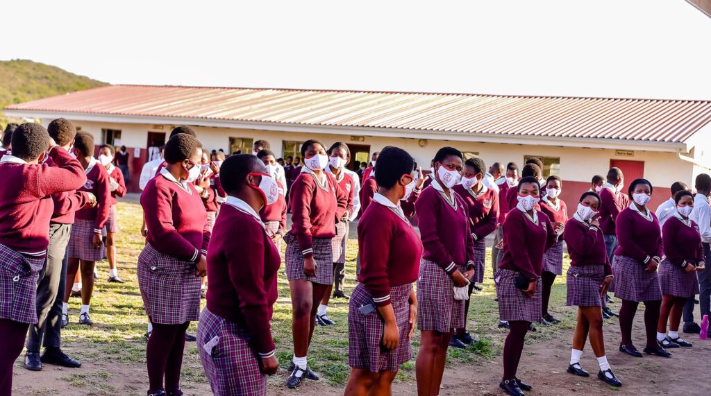 GIrls in a maroon school uniform